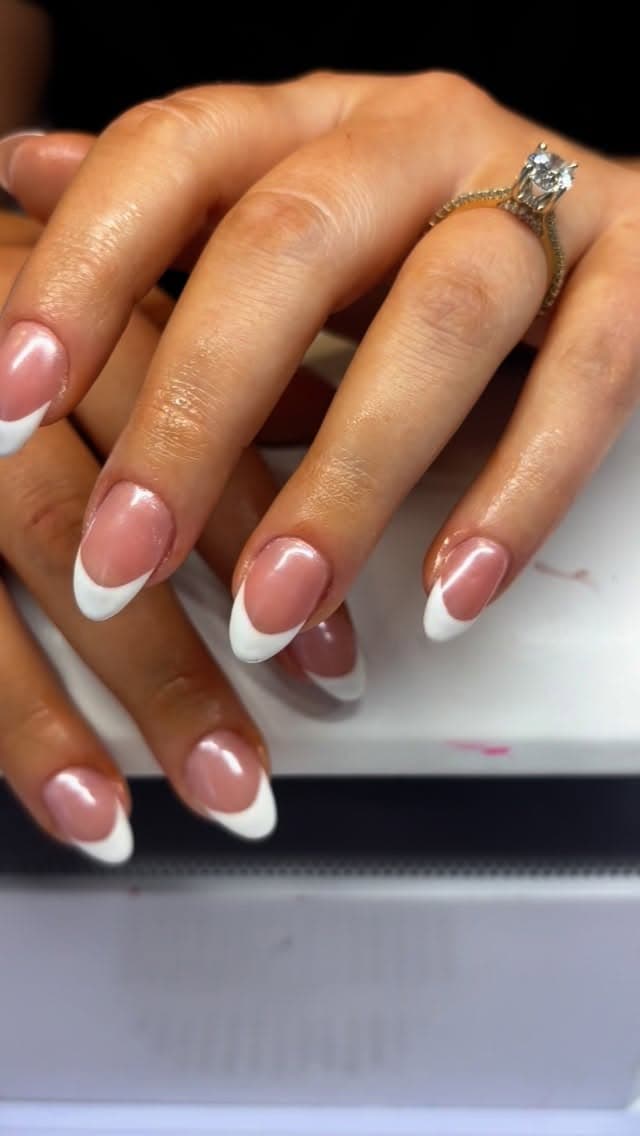 Close-up of a custom French-tip nail set by Resilient Glam Studio