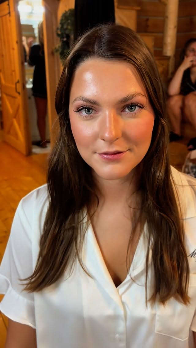 Client ready in a satin robe after a makeup application